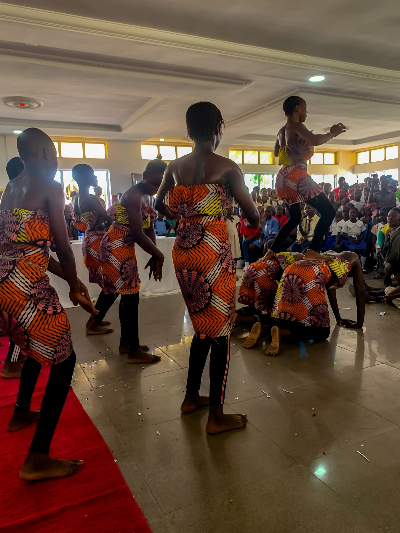 Children performing a cultural dance during a YVEI community gathering