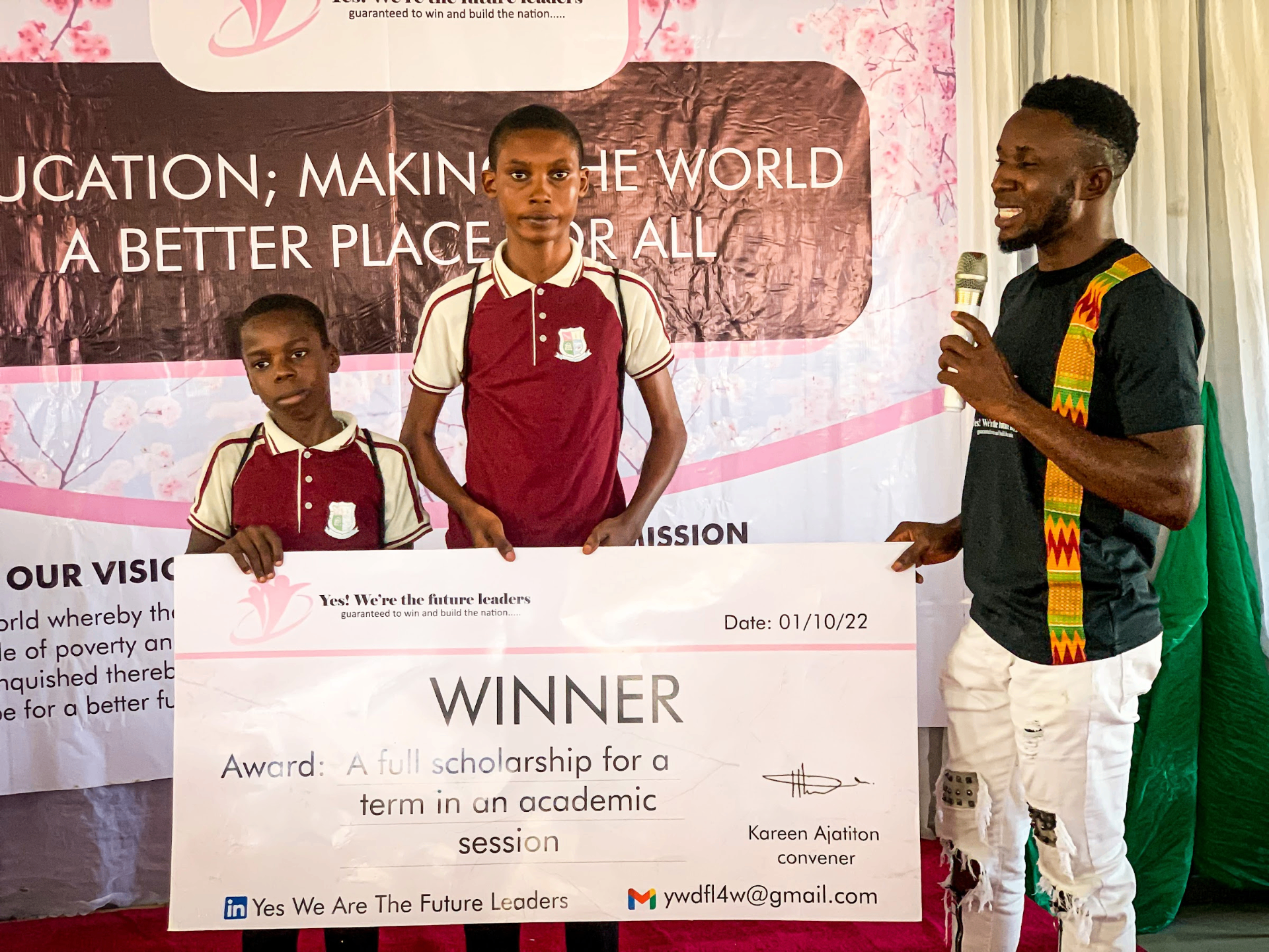 A student receiving a full-term academic scholarship award from YWTFL in 2022